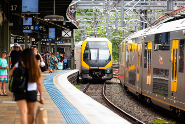 Melbourne train platform with waiting passengers and approaching train