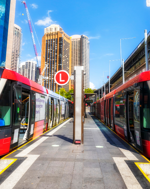 two trams pulling up to a platform