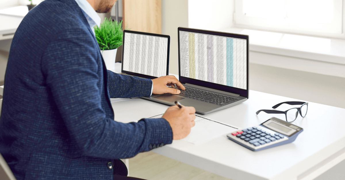 man sitting in excel spreadsheets for business reporting